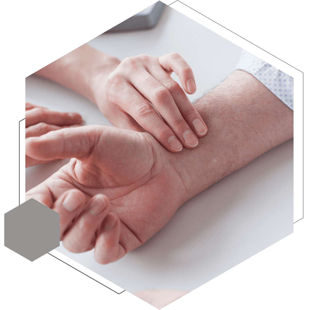 Person checking another person's pulse on the wrist using their fingers, set within a hexagonal frame.